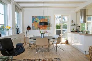 a kitchen and dining room with a table and chairs at Historical beachhouse in Snekkersten in Snekkersten