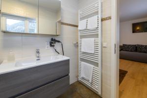 a bathroom with a sink and a mirror at Gasthof Waldwirt in Russbach am Pass Gschütt