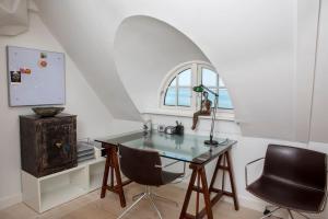 a desk and two chairs in a room with a window at Historical beachhouse in Snekkersten in Snekkersten +40 photos