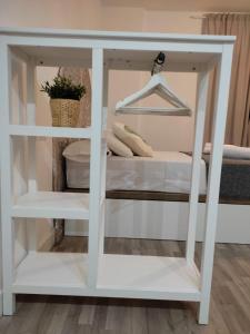 a white book shelf with a bed in it at VFT Puerta de Córdoba in Baeza