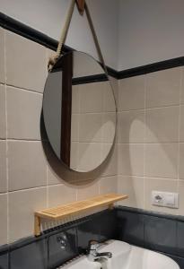 a bathroom with a mirror and a sink at VFT Puerta de Córdoba in Baeza