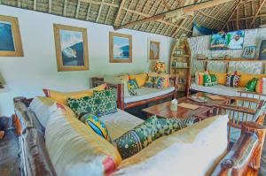 a living room with couches and a table at Mvuvi Fishing Lodge in Watamu
