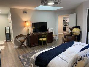a bedroom with a bed and a flat screen tv at Relax @CercaDelPlaya: .7mi to the Beach! 4BR/2.5BA in San Diego