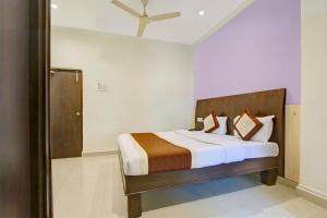 a bedroom with a large bed in a room at Collection O 9796 Hotel Alekhya Residency in Hyderabad