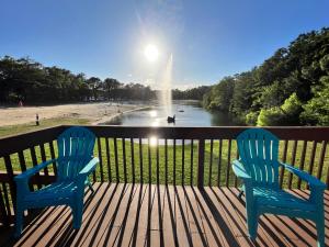 two blue chairs on a deck with a view of a fountain at Pine Haven in Cape May Court House