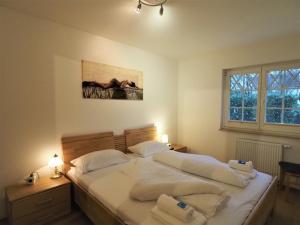 a bedroom with two beds and a painting on the wall at Villa Sola Bona, FW 2 in Zingst