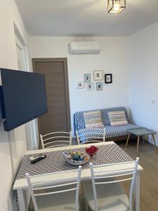 a living room with a table and a couch at Cà di GIACO in Moneglia