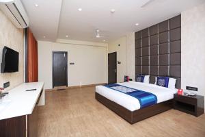 a hotel room with a bed and a desk at Niharika Guest House in Guwahati