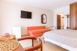 ein Hotelzimmer mit einem Bett und einem Sofa in der Unterkunft Bed & Breakfast Kaštel in Žbandaj
