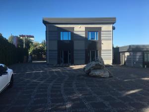 a house with a rock in front of it at Mały domek kawalerka in Starachowice