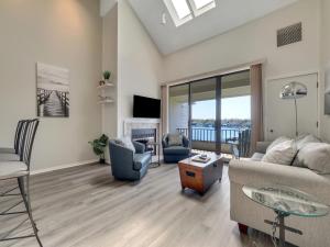 a living room with a couch and chairs and a table at 359 Edgewater Inn in Charlevoix