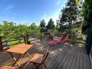 two chairs and a table on a wooden deck at Wohnen im Grünen in der Nähe von Leipzig in Machern +8 photos