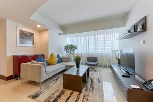 a living room with a couch and a table at Jumeirah Living World Trade Centre Residence, Suites and Hotel Apartments in Dubai