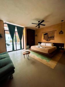 a bedroom with a bed and a ceiling fan at Hotel Bohonito Holbox in Holbox Island