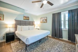 a bedroom with a large bed and a ceiling fan at 5BR Combined Units with Hot tub and Grill in Woodstock