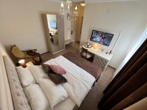 a bedroom with a couch and a television in it at International Inn in Paraćin