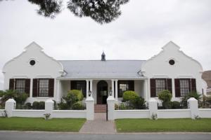 una casa blanca con una valla blanca en Laings Lodge, en Laingsburg