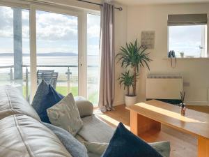 a living room with a couch and a table at Heddfan in Llanelli