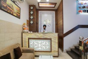 a room with a fireplace and a person in a mirror at Super Townhouse 561 Hotel Hollywood Heights in Amritsar