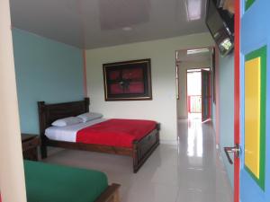 Postel nebo postele na pokoji v ubytování Finca Hotel Guayacundo