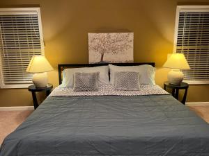 a bedroom with a large bed with two lamps at Five Stars Luxury Home in Clarksville