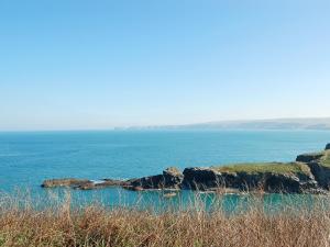 a view of the ocean with rocks in the water at Mainbrace in Port Isaac