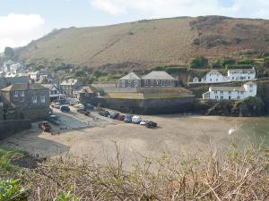 a small town with a bunch of houses and a hill at Mainbrace in Port Isaac