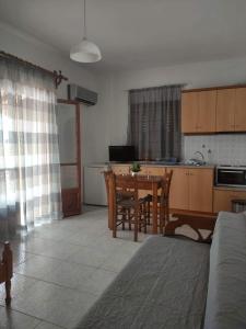 a living room with a kitchen and a dining room table at Mata's House in Skiathos Town