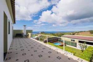 a balcony with a view of the ocean at Azores Mountain View in Ribeira Grande