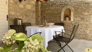 a table with chairs and a white table cloth at Heritage house Dvor in Sutivan