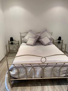 a bed in a bedroom with two lamps on the floor at jolie appartement avec piscine in La Roquette-sur-Siagne