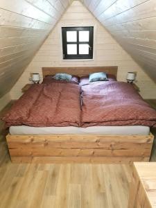 a bed in the middle of a room at U Toma in Malá Morávka