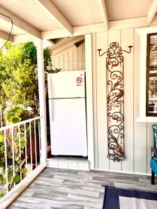 a refrigerator on the front porch of a house at Upgraded, Stylish & Comfy 1 Bedroom/1 Bath Studio in Payson