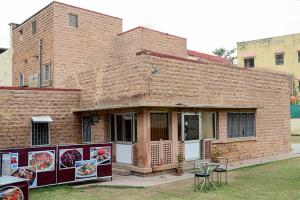 a brick building with paintings on the side of it at Collection O 4255 Day Night Guest House And Restaurant in Mahāmandir