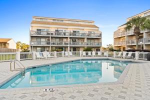 a swimming pool in front of a apartment building at Endless Summer by Panhandle Getaways in Panama City Beach