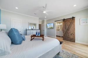 a bedroom with a bed with a blue pillow and a table at Luxury 5BR Gulf Shores Oceanfront +Pool &Amenities in Gulf Shores