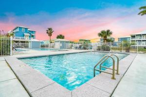 a swimming pool in front of some houses at Luxury 5BR Gulf Shores Oceanfront +Pool &Amenities in Gulf Shores