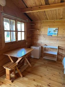 a log cabin with a picnic table in the room at Karjamaa Garden Bungalows in Pärnu