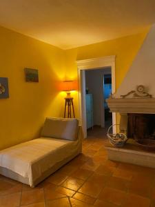 a yellow room with a bed and a fireplace at Villa Lu in Porto Cesareo