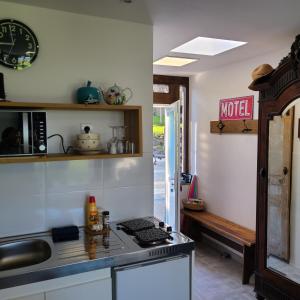 a kitchen with a stove and a counter top at Studio L'audrerie. in Saint-Pardoux-Corbier