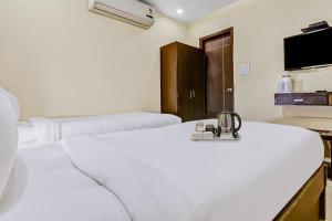 Postel nebo postele na pokoji v ubytování OYO Townhouse 852 Hotel Vachi Inn