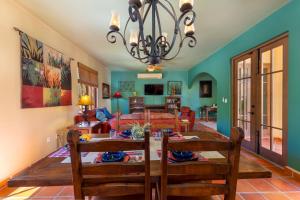a dining room and living room with a table and chairs at Casa Patricia in Loreto