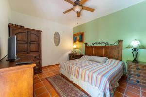 a bedroom with a bed and a flat screen tv at Casa Patricia in Loreto +30 photos