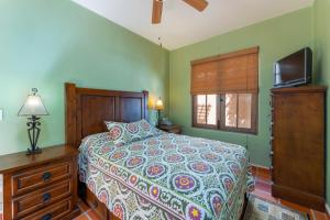 a bedroom with a bed and a flat screen tv at Casa Patricia in Loreto