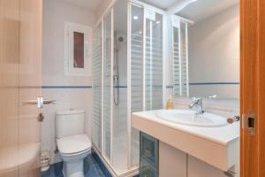 a bathroom with a toilet and a sink and a shower at Vivienda Turística Portal de Teruel in Teruel