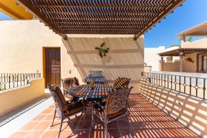 a patio with a table and chairs on a balcony at Casa Patricia in Loreto