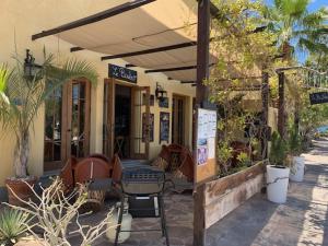 a restaurant with a table and chairs under an umbrella at Casa Patricia in Loreto