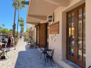 a patio with tables and chairs outside of a building at Casa Patricia in Loreto