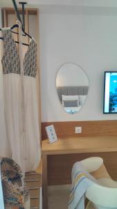 a dressing room with a mirror and a desk at Mina's House Beachfront Apartments in Nikiti