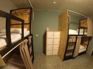 a room with two bunk beds and a room with at Liuqiu Hostel 杉橘青年旅店 in Xiaoliuqiu